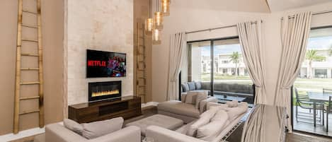 Open living space with Smart TV, fireplace, and patio access