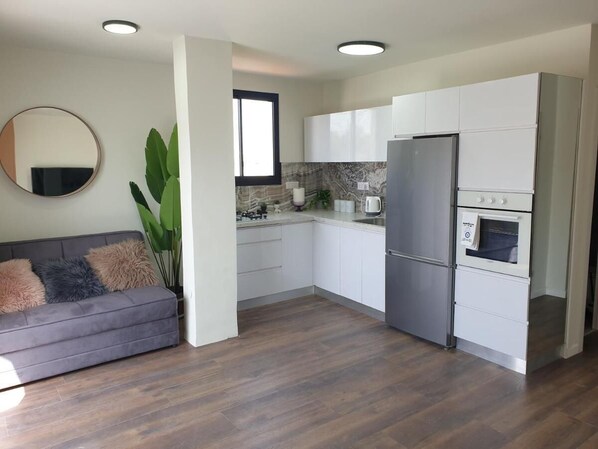 full Kitchen including refrigerator, stove, utensils and coffee   