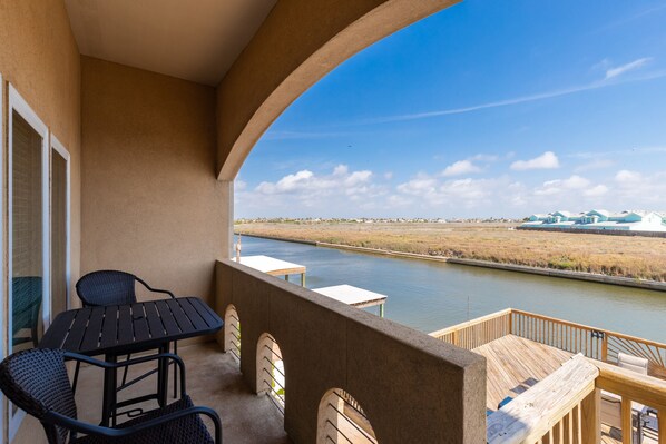 Private balcony off the living area with table and chairs
