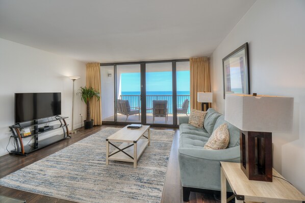 An oceanfront living room provides a comfortable place to spend time with family