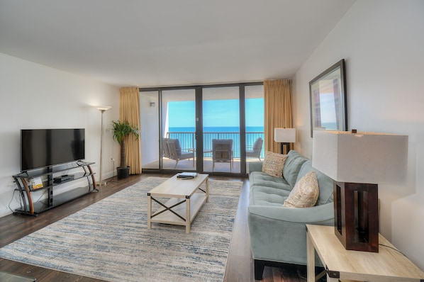 An oceanfront living room provides a comfortable place to spend time with family