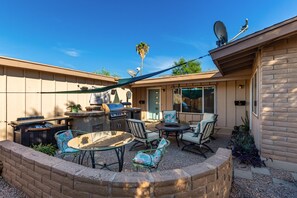 Courtyard with grill, firepit and pizza oven