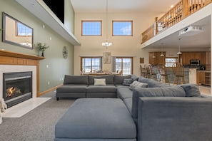 The living room has a 55” smart tv and large sectional sofa