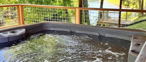 Want to wind down in this hot tub and relax? Relax in the hot tub and hear the river in the background. This is one of the only waterfront homes with a hot tub in the area.