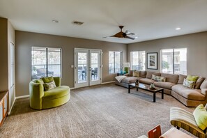 Living room with very comfy couch and swivel chair plus two occasional chairs