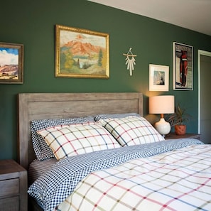 Master Bedroom with curated artwork & luxurious bedding. It's all in the details!