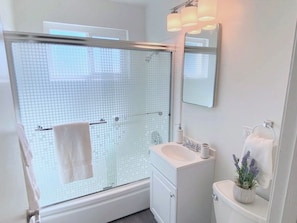 Bathroom is light and bright with a shower over tub layout