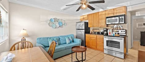 Bright living room with smart tv and equipped kitchen w/ coffee machine & pods