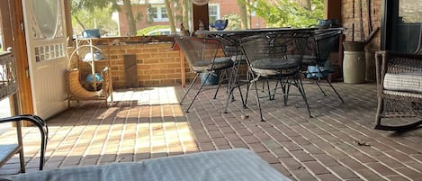 Cozy screened patio for family gathering.