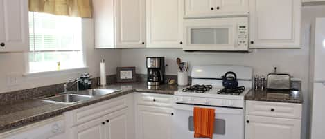 Beautiful kitchen with every utensil, stocked by a professional chef.