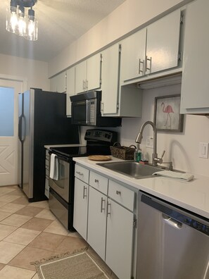 Kitchen with new quartz counters and a new microwave