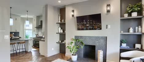 Step into this welcoming living area,  seamlessly flowing in the chef's kitchen.