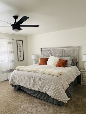 Master bedroom with king bed and smart TV . Ceiling fan 