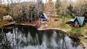View of our three cute A-frames situated around our private pond. 