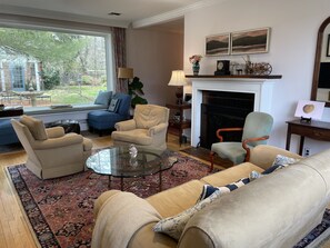 Living room with gas fireplace, taken with view to the backyard
