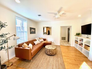 Large open living area. Comfortable leather sofa with modern decor.