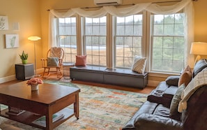 Bright living room overlooks a pond