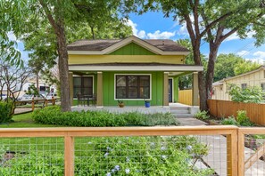 Front of home.  Seating for four with roller shade on front porch