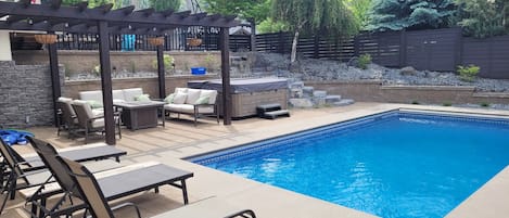 Epic backyard oasis.  Beautiful pool, hot tub, lounge chairs and couches.