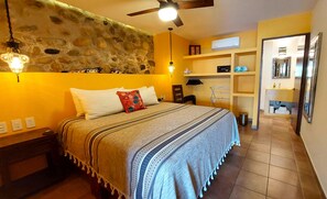 Curiel's Retreat Bedroom 1 with beautiful natural stone wall, safe, open closet