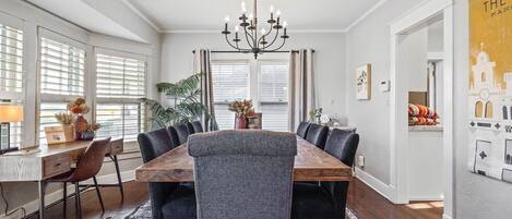 A large dining room table has ample seating for a group of 8