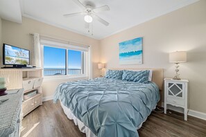 This charming bedroom offers a comfortable bed with vibrant linens, complemented by practical storage solutions. A delightful space to unwind.