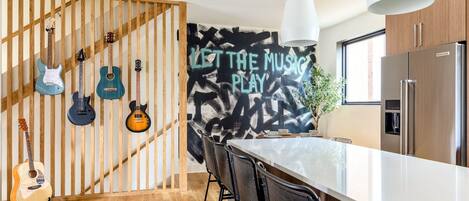 You heard the man, let the music play! Our spacious, open second floor features a fully stocked kitchen with plenty of dining space. Perfect to host your group, strum on our acoustic guitar, or cozy up near the fireplace.