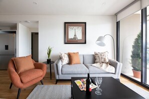 Surely you can relax on a comfy sofa in this large, bright, modernly furnished living room.