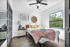 This bright and airy bedroom offers a perfect blend of comfort and style, featuring a plush bed, soft linens, and modern decor. With large windows allowing natural light to pour in, you'll wake up refreshed and ready to explore. Relax in this peaceful retreat and enjoy a restful night's sleep during your stay.