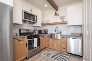 Full size kitchen with Keurig machine, K-cups, and all your standard cooking and eating utensils.