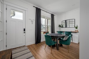 Front room welcomes you with table with poker top and bar