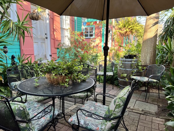 Your private patio with umbrella and furniture.  (Door to your cottage, too!)