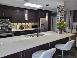 Marble kitchen island with bar stools.