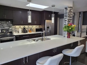 Marble kitchen island with bar stools.