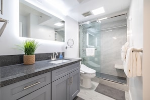 Remodeled bathroom with walk in shower. Bidet on the toilet