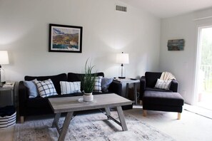 Step into this cozy living room oasis! With its inviting couch and stylish coffee table, it's the perfect spot for relaxation or gathering with friends.