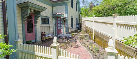 Front of home with delightful outdoor space and native plantings