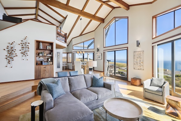Panoramic ocean views from the floor-to-ceiling windows in the back of the house. Three separate sliding glass doors take you to the back yard with a large deck and spa.