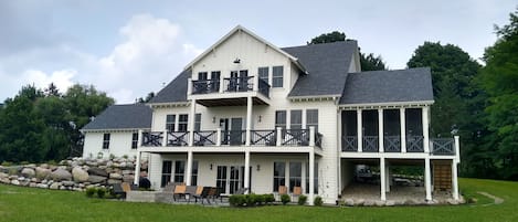 Back Yard Featuring Decks, Screened Porch, and Bluestone Patio Overlooking Lake