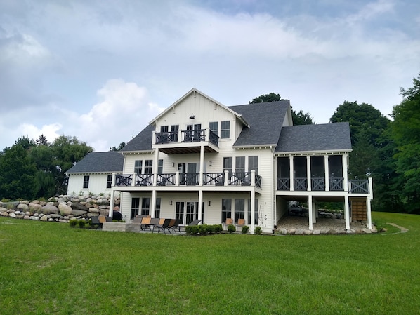 Back Yard Featuring Decks, Screened Porch, and Bluestone Patio Overlooking Lake