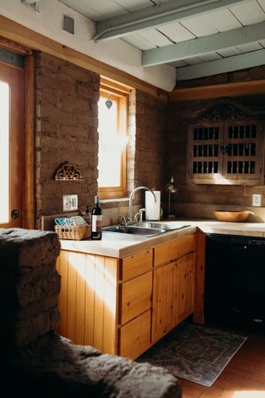 The kitchen window looks out to the back of the property, where you can see the fire pit