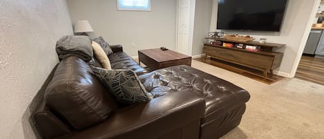 Soft leather couch and large screen (65") smart tv in main living space