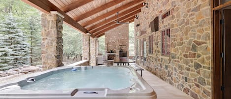 Huge hot tub on the covered stone patio