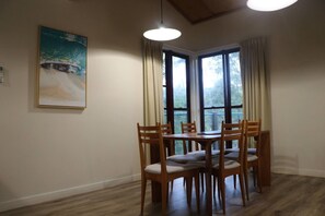 Dining room with lovely artwork and the perfect outlook to the treetops.