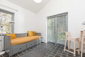 The stylish bedroom includes a stylish grey double sofa bed.