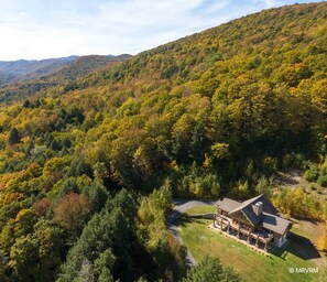 Aerial view of the house and surrounding mountains