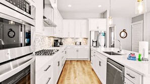 Our kitchen has all the essential cookware, full-sized stove/oven, microwave, and dishwasher.