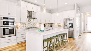 On your right, you'll find a fully-equipped chef's kitchen where you can cook in.