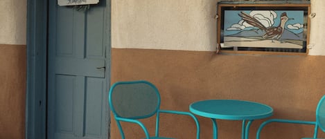 The main entrance and patio with a hand-painted window featuring a roadrunner