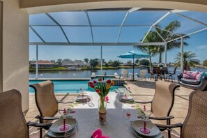 Villa Blissful Bay - Outdoor dining with a view of the pool and Gulf